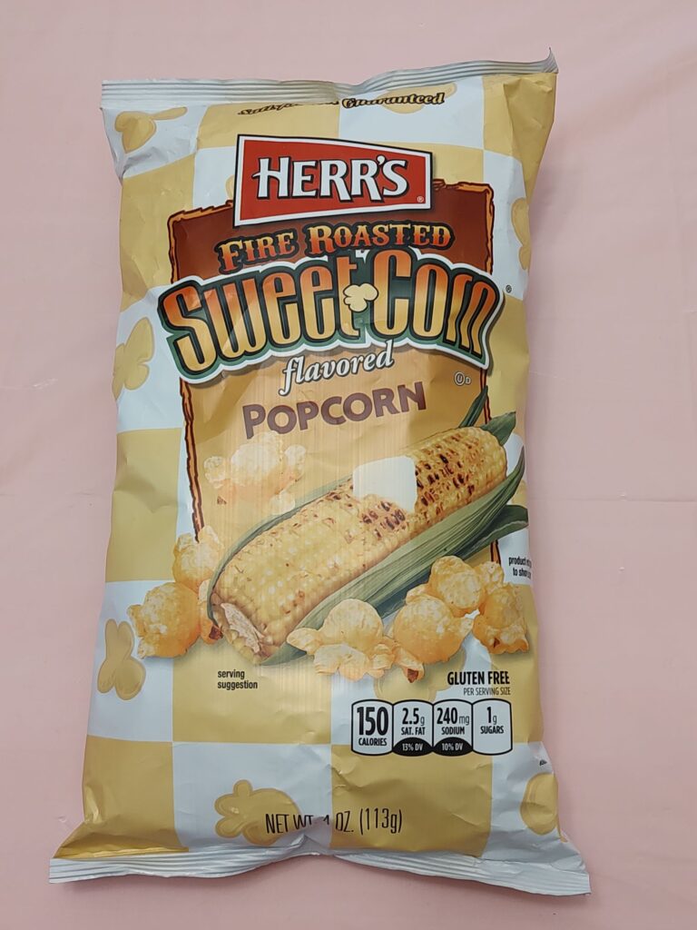 A bag of popcorn is sitting on the table.