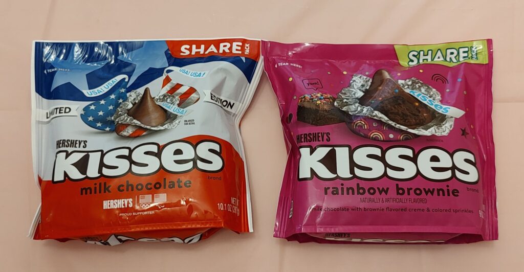 Two bags of candy are sitting on a table.